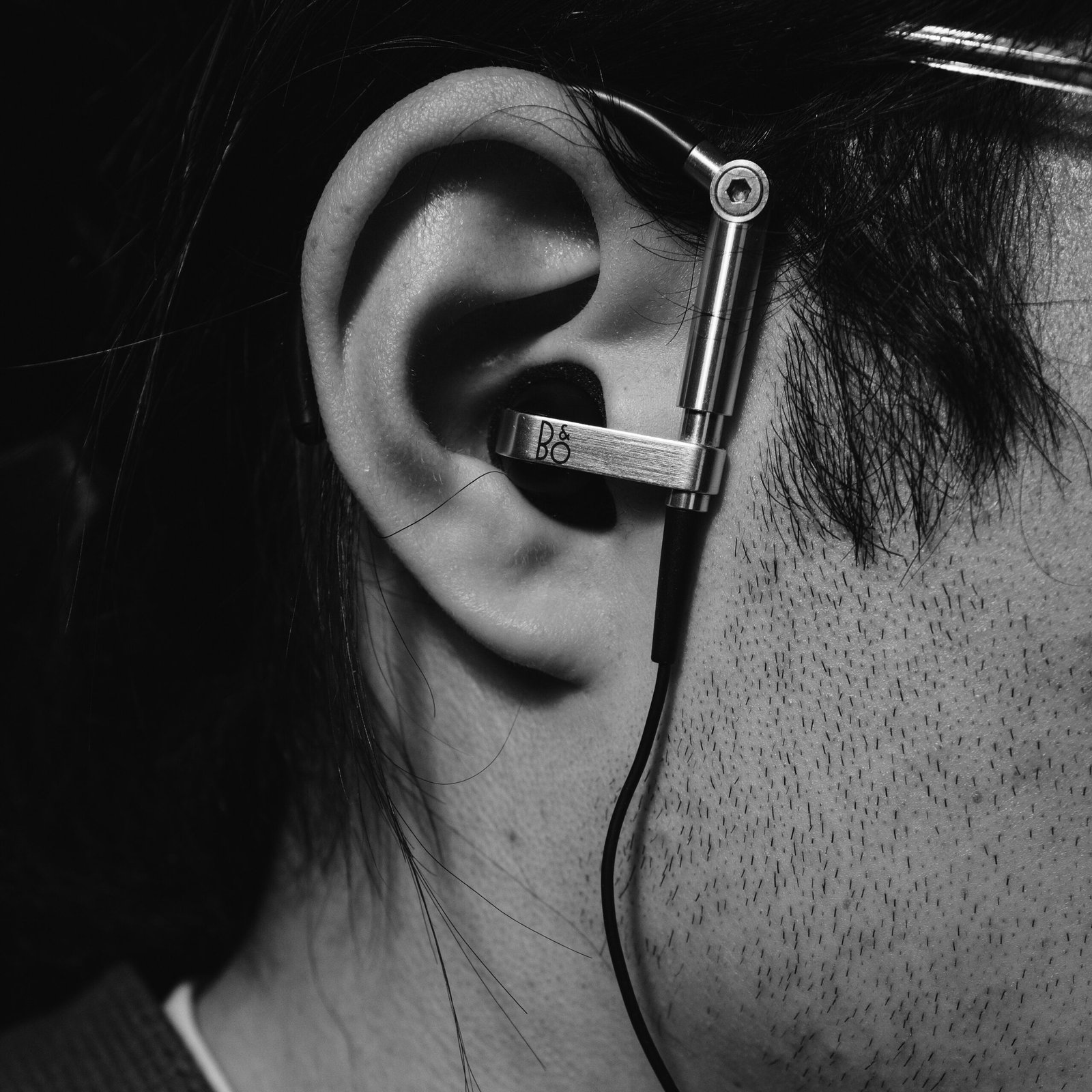 An in-ear headphone being worn