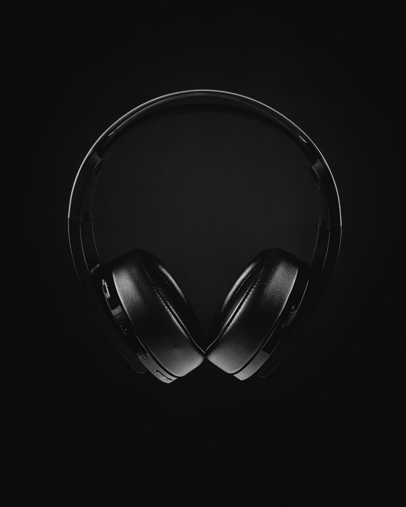 Black headphones against a dark background
